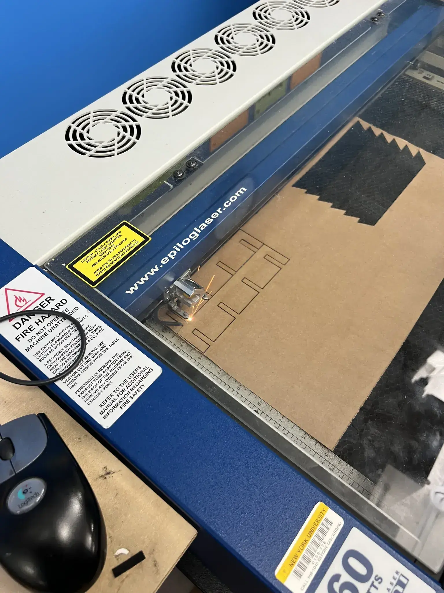 Photograph of a laser cutting cardboard spacers