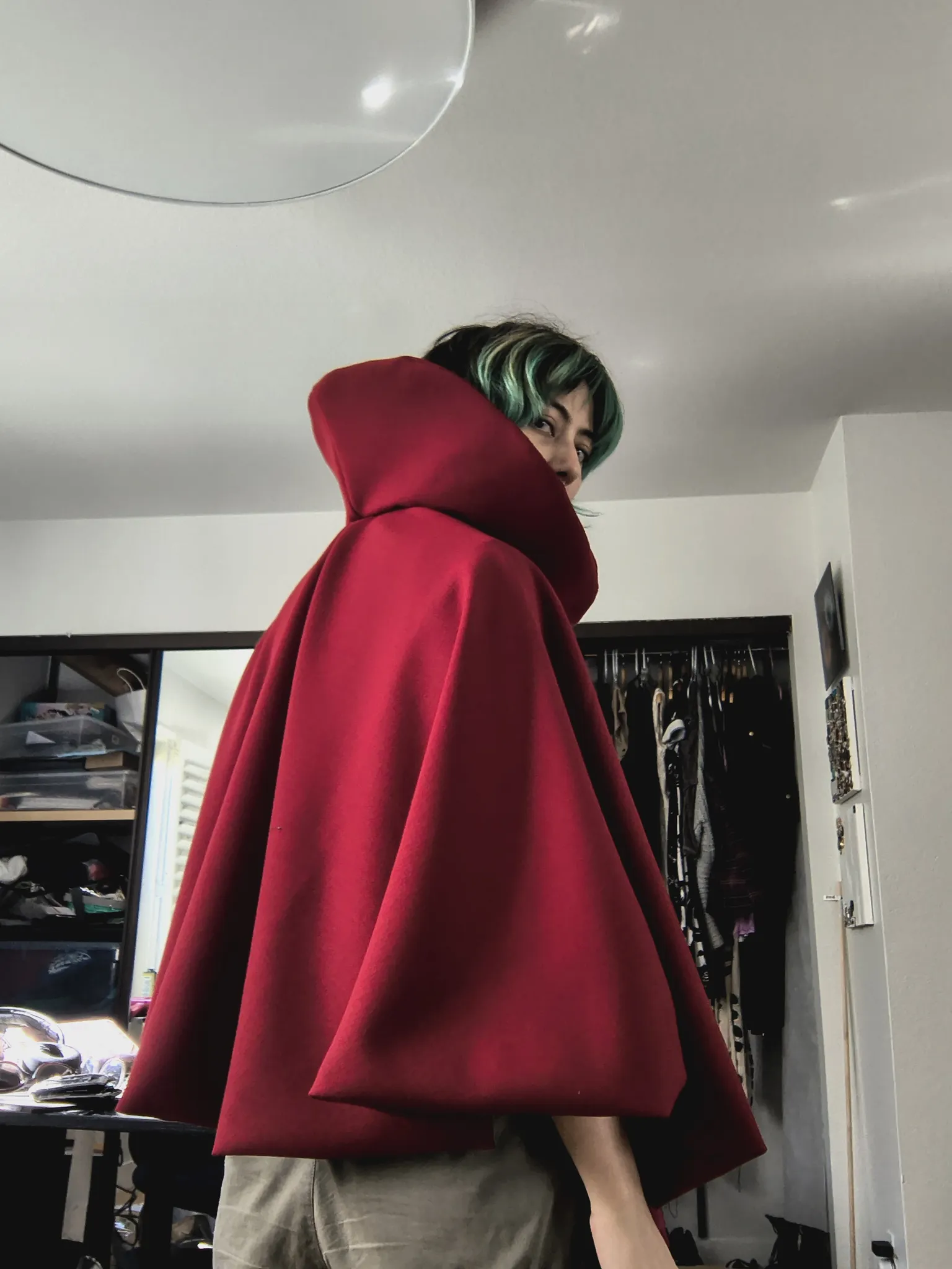 The back of the red cloak, showing how it drapes to the elbows