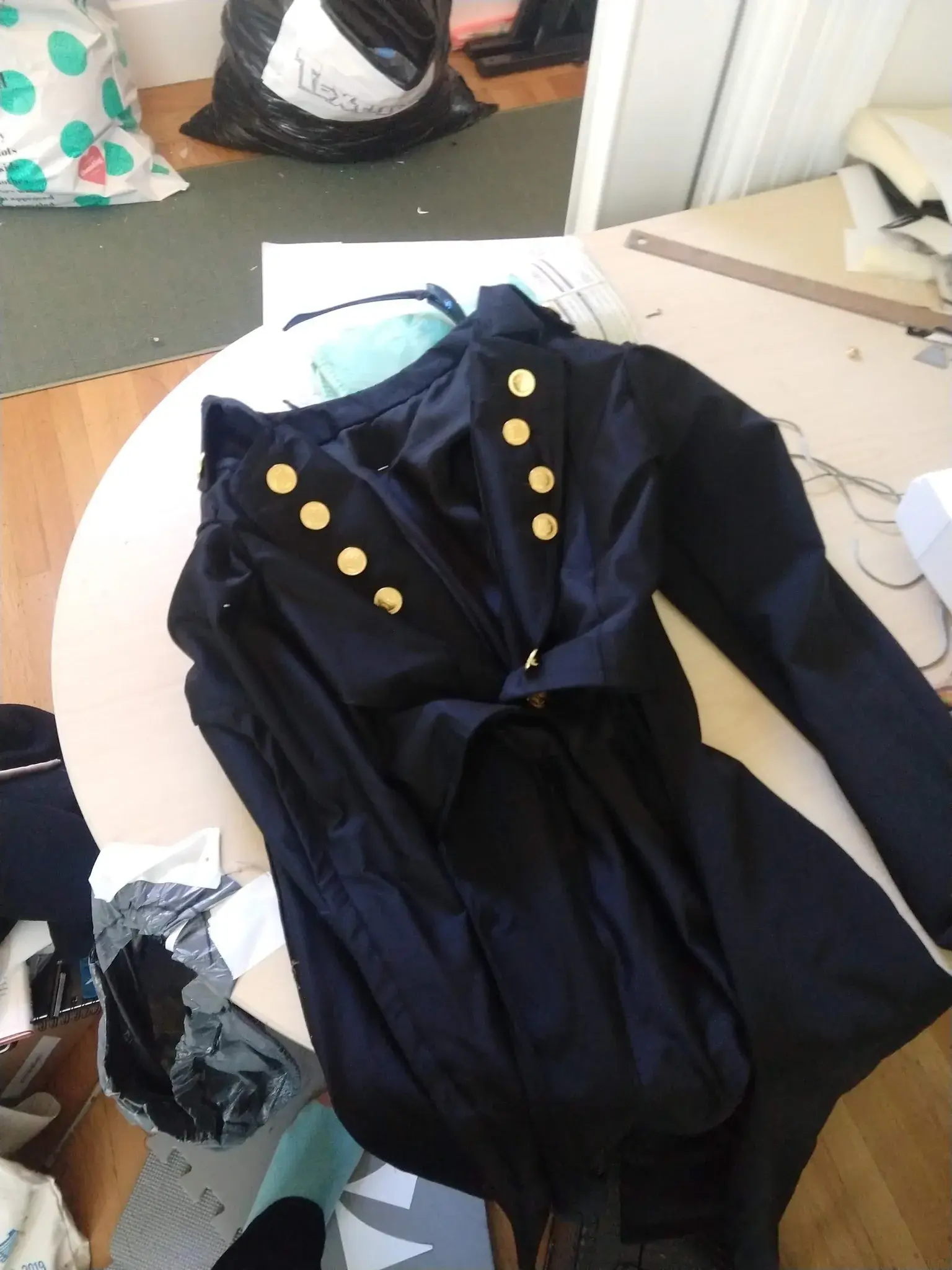 Photograph of a finished jacket laying face up on a table