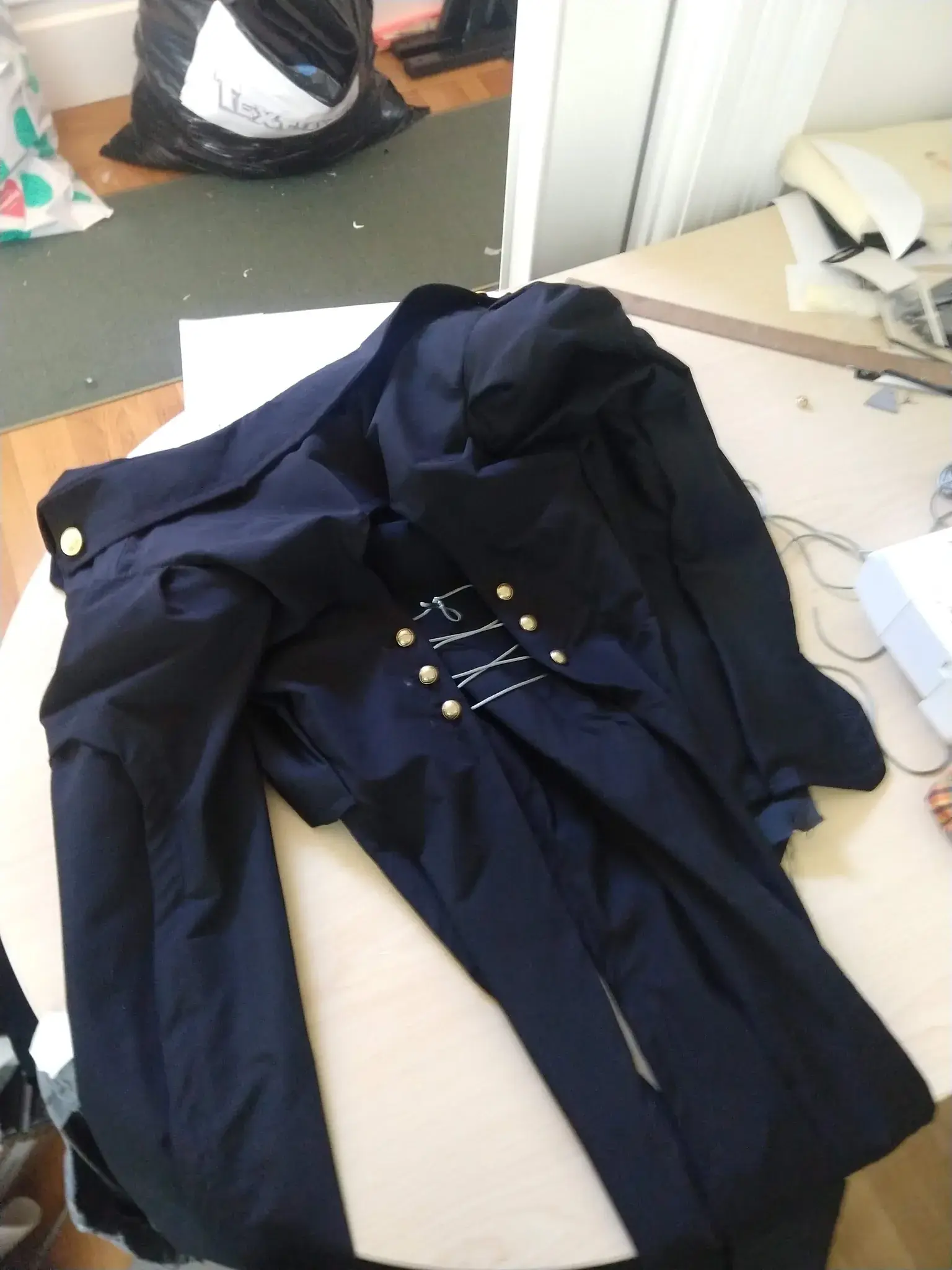 Photograph of a finished jacket laying face down on a table