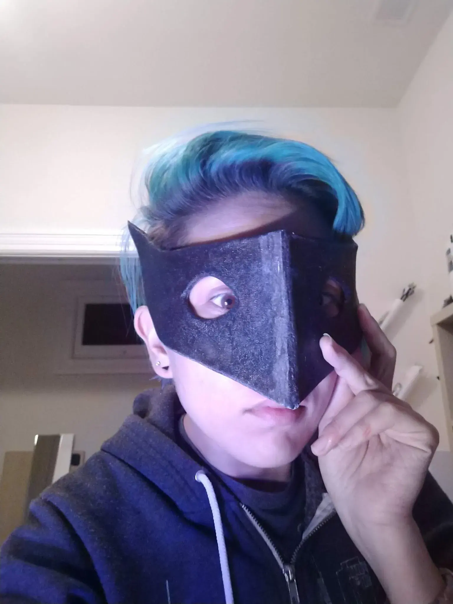 Photograph of a person wearing a black mask