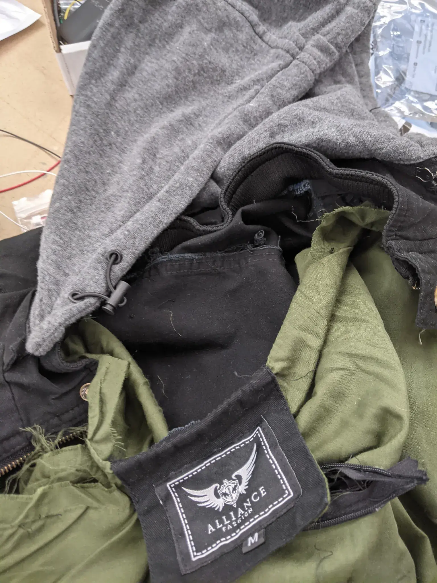 Photograph of a jacket being seam-ripped