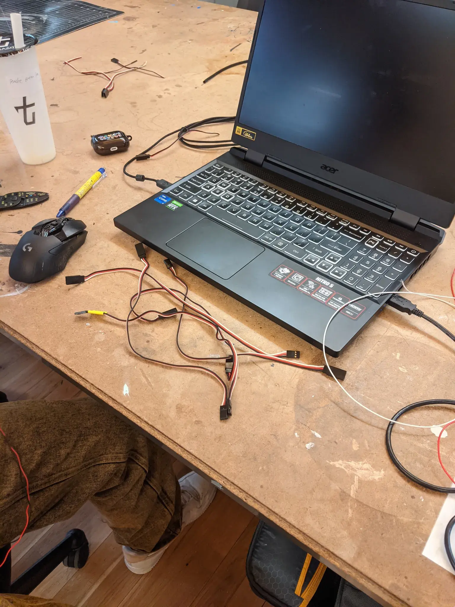 Photograph of a messy desk covered in wires
