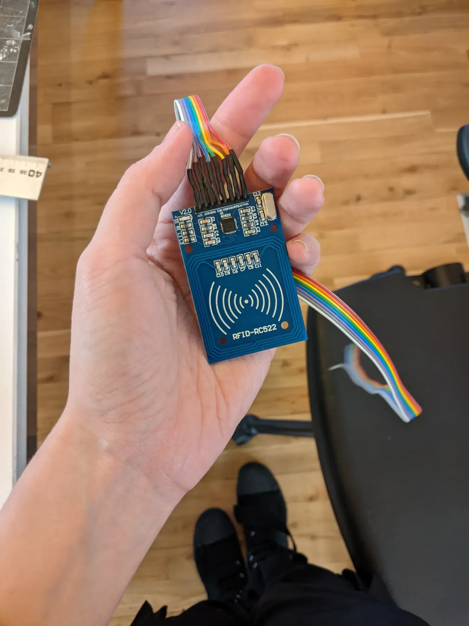 Photograph of a small RFID reader with a ribbon of wires soldered on