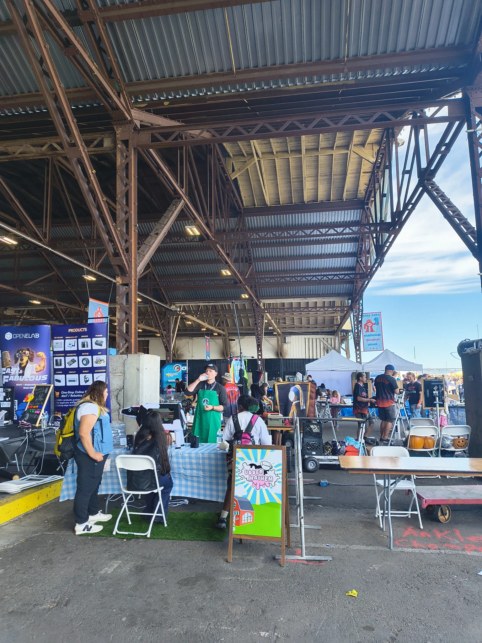 Photograph of the booth from across the hall, with the ships of Mare Island behind it